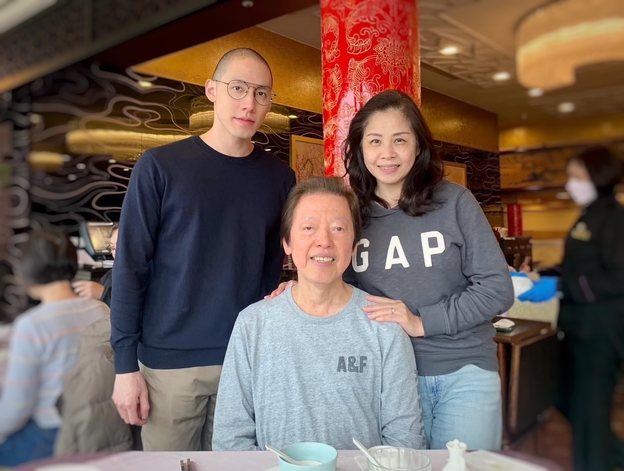 Doctor Lo at a restaurant table with a woman and a man